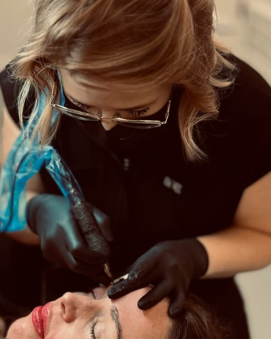Kyla Paris performing a permanent brow enhancement treatment on a client.